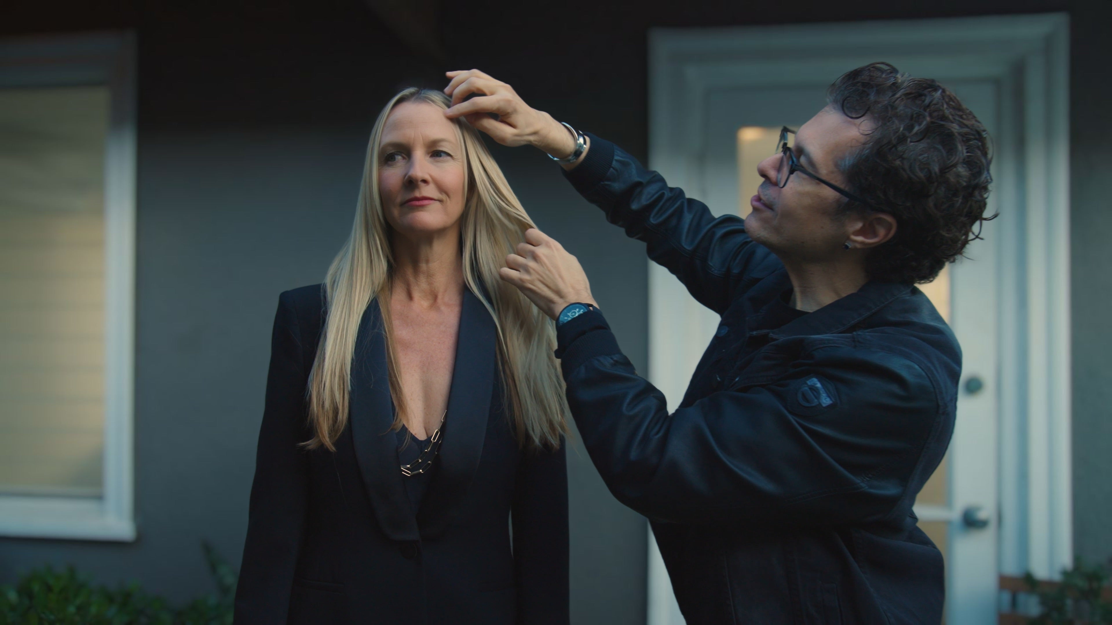 Marco Pelusi adjusting a gorgeous model's long blond hair with his signature highlights after a hair color session at his west hollywood hair studio
